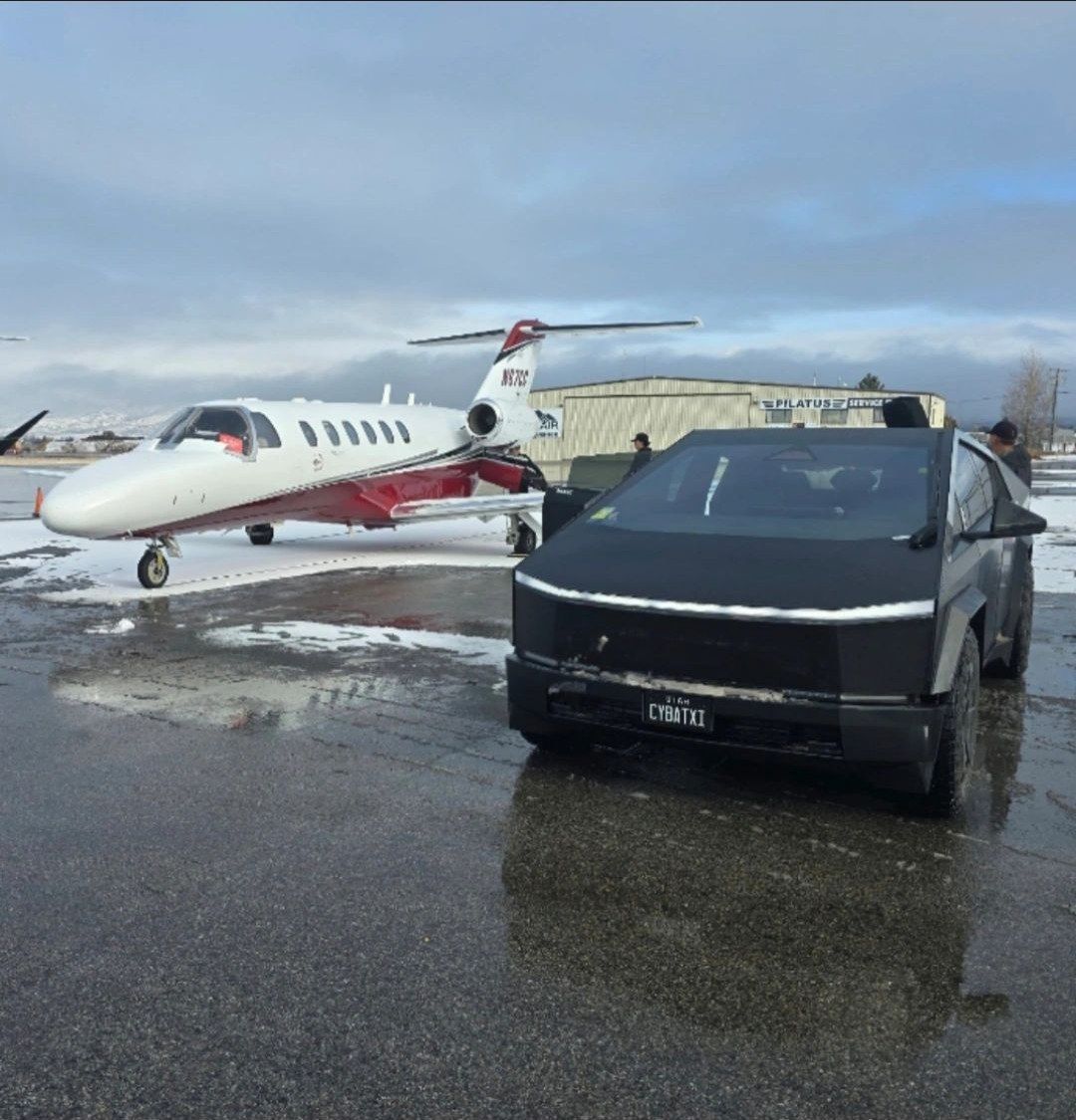 CyberTaxi Cybertruck parked planeside next to a private jet