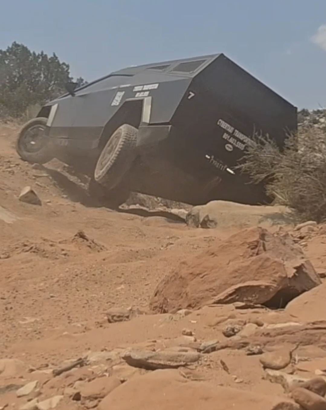 CyberTaxi Cybertruck climbing off-road terrain near Moab