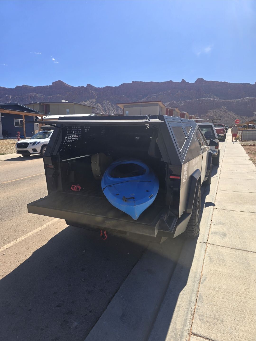 Kayak loaded in the CyberTaxi covered bed on a Moab street